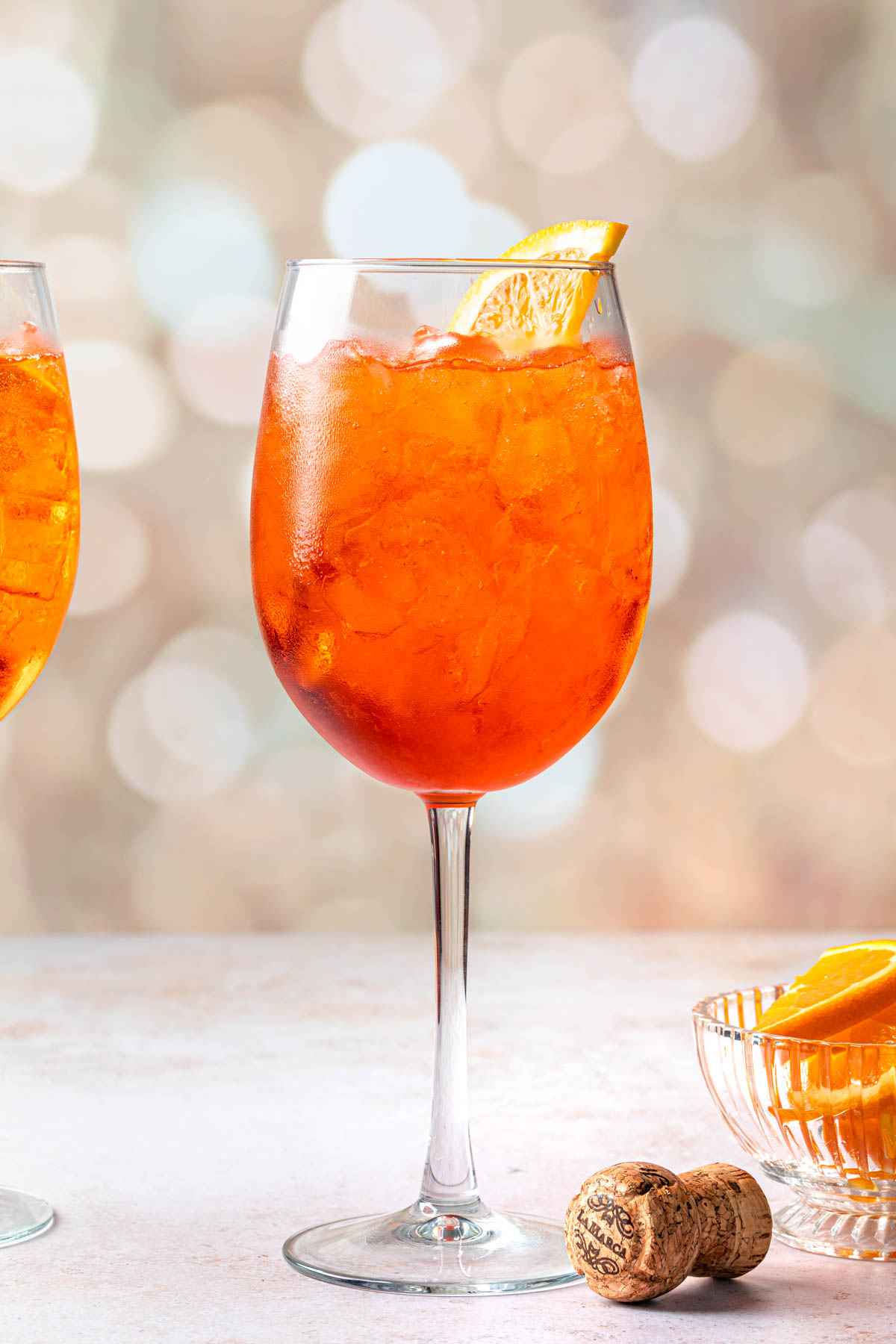 Aperol Spritz served in a wine glass with orange slice garnish